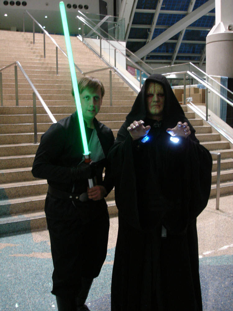A cosplayer dressed up as luke standing next to a cosplaying emperor, foreshadowing Luke's future