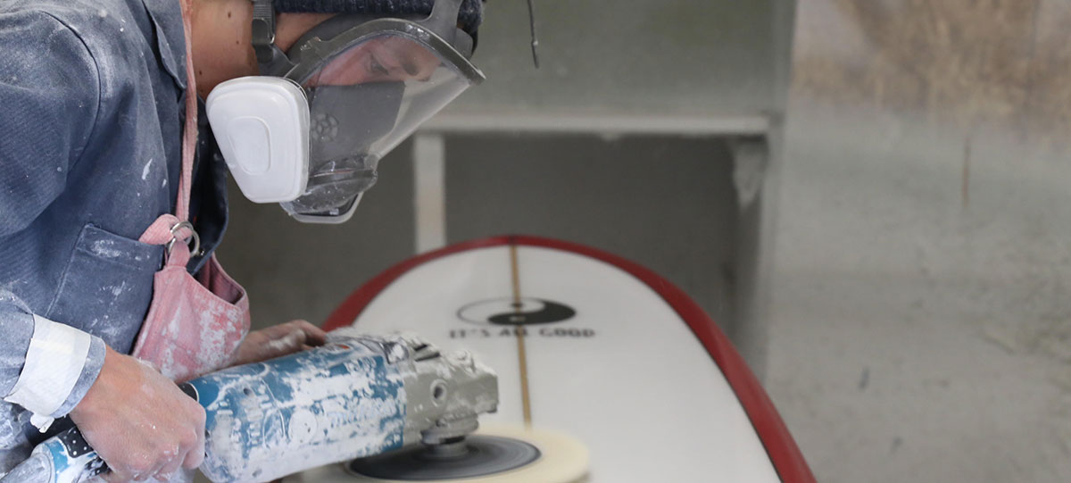 Blake Hansen buffs out a board at the shop in Oceanside, California. (Timmy Heffernan)
