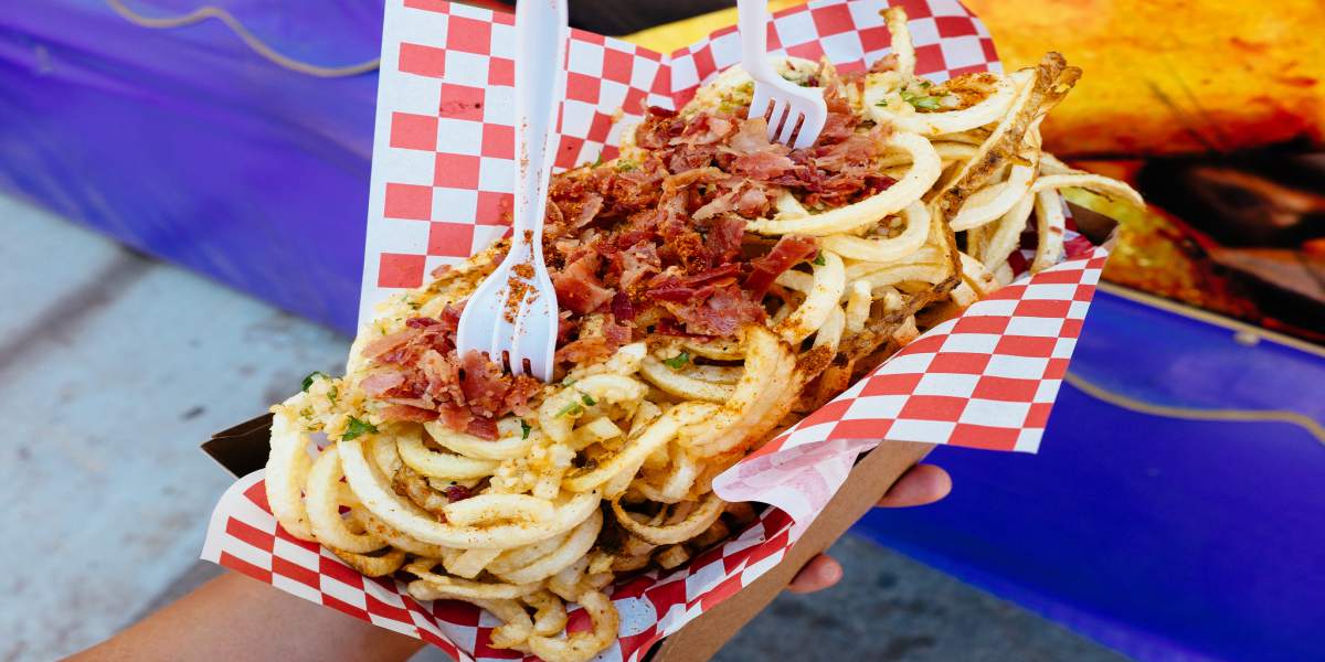 Rich bacon and onions embellishing fair food. (Michael Saechang/ Flickr)